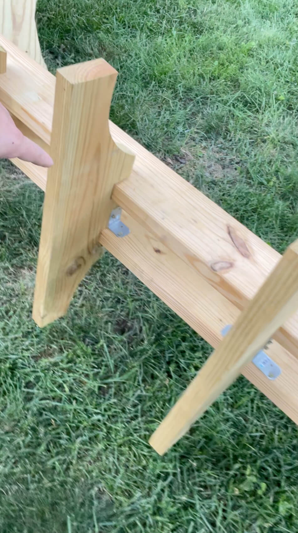 Using brackets while building a backyard hammock stand.